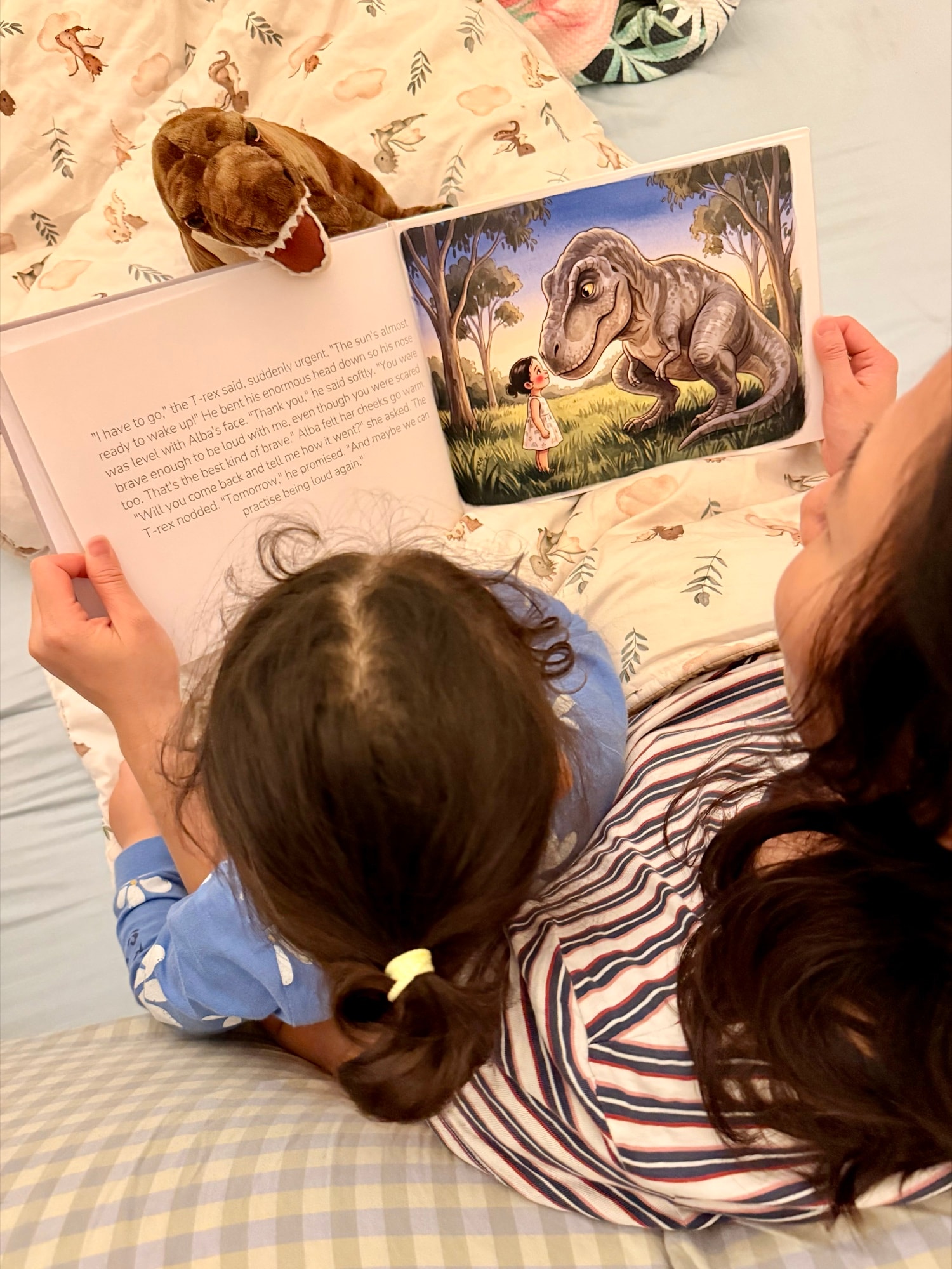 A child at bedtime reading their personalised Almia hardcover storybook, with the illustrated character on the page matching them